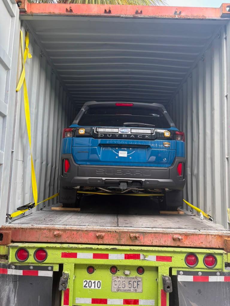 Subaru Outback loaded and strapped inside a shipping container for export